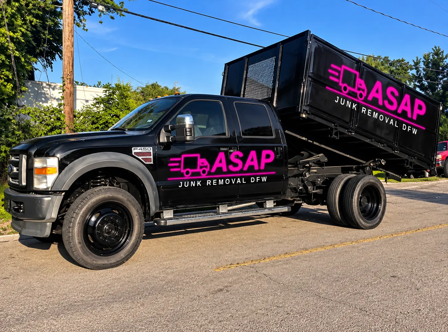 ASAP Junk Removal DFW black Ford F-450 pickup with dump bed and neon pink ASAP logo